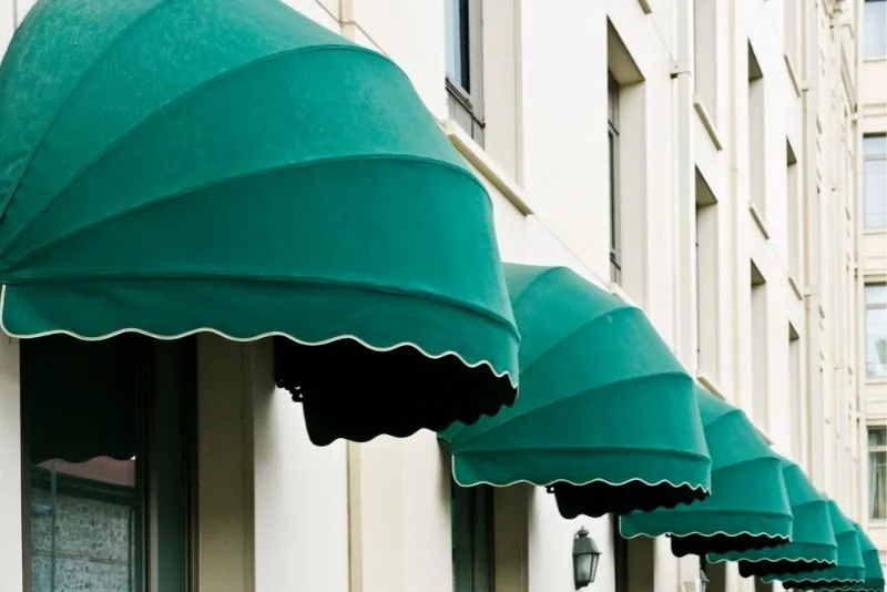 Green fabric awning shading a window on a Gold Coast home