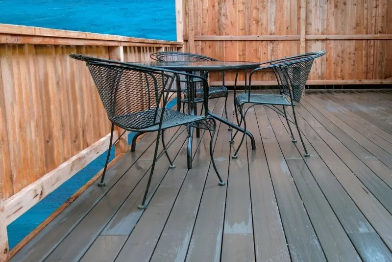 Wet-look composite deck boards with a wrought-iron table and chairs