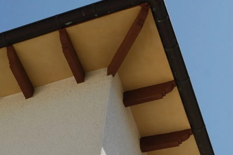 Timber eaves extending over a home's exterior wall