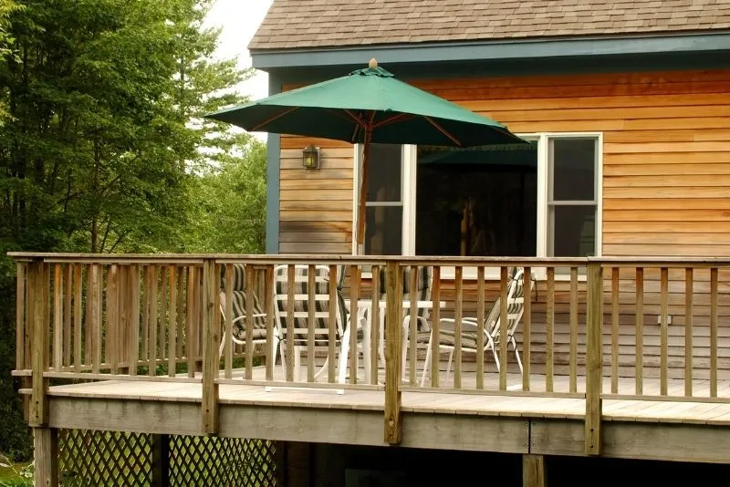 Timber deck with railing, dining table and outdoor umbrella
