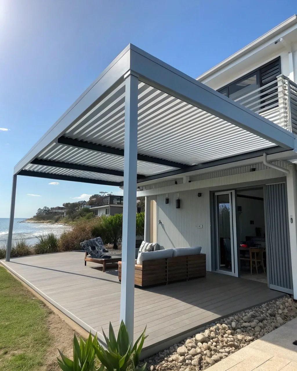 A motorised louvred roof pergola attached to a mod