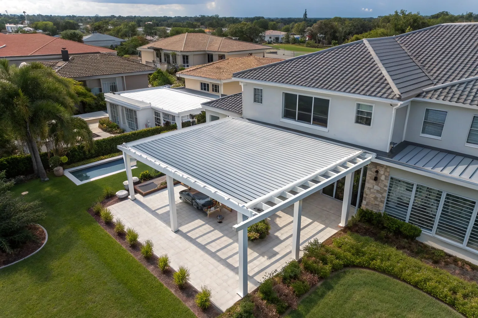 White aluminium pergola attached to a home, viewed from above