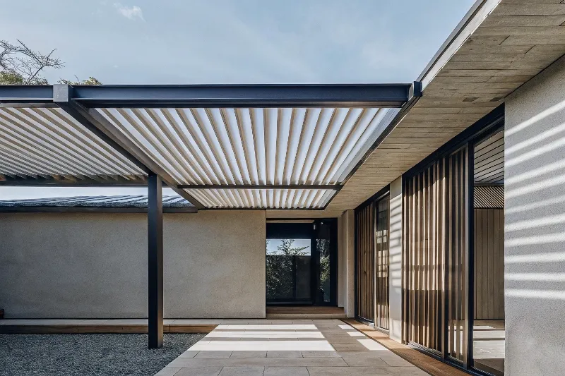 Architectural visualisation showing seamless transition between interior living room and pergola-covered outdoor area with matching flooring materials