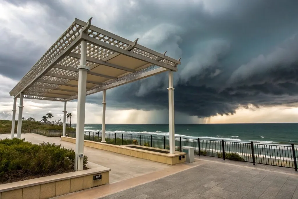 Smart pergola system with weather protection features integrated into luxury Burleigh Heads home at sunset with Burleigh beach backdrop