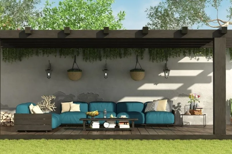 Dark timber pergola shading an outdoor lounge seating area